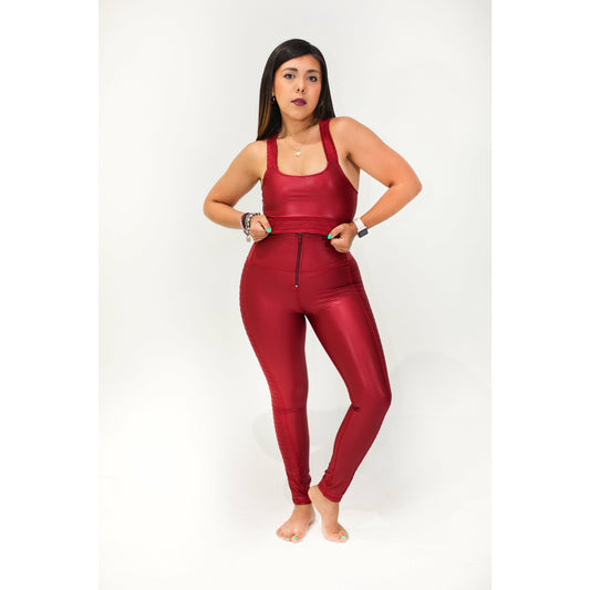 A model wearing a burgundy sleeveless top and matching high-waisted leggings with a leather effect.