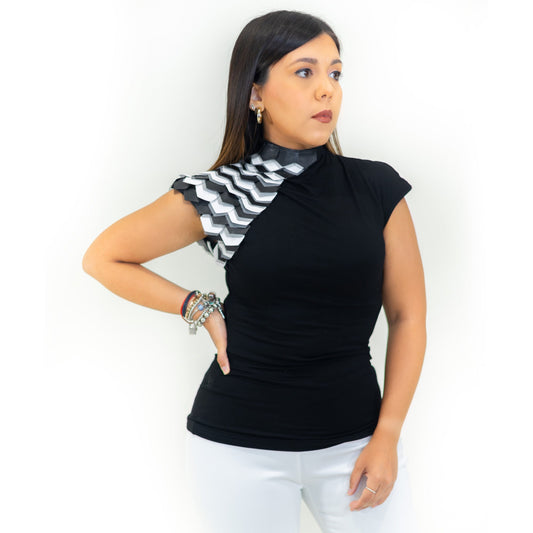 A model wearing a black short-sleeved blouse with leather details on the side and a high neck.